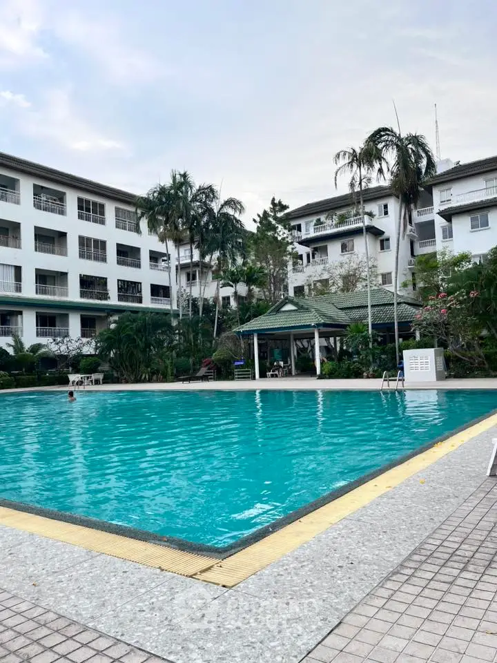 Luxurious apartment complex with inviting pool and lush greenery, perfect for relaxation and leisure.