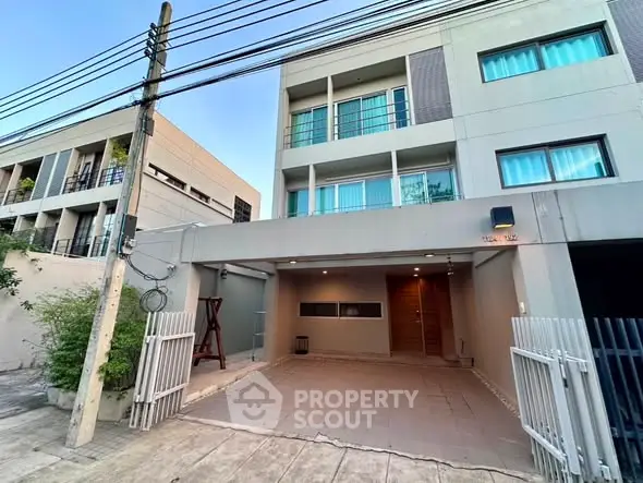 Modern townhouse exterior with gated entrance and spacious driveway