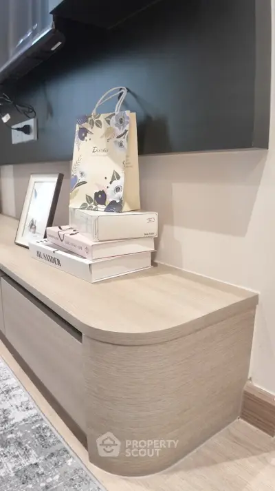 Modern living room with stylish wooden console and decorative items, perfect for contemporary interiors.