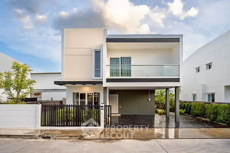 Modern two-story house with sleek design and spacious balcony in a serene neighborhood.