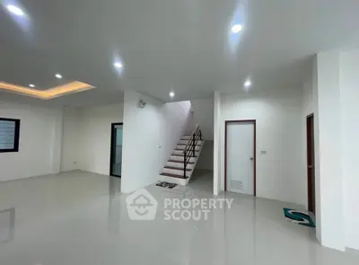 Spacious modern interior with sleek staircase and recessed lighting