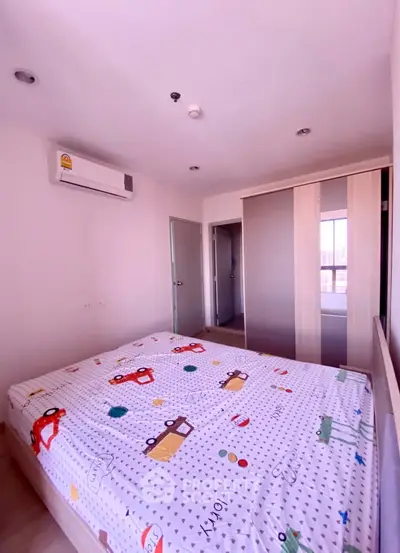 Cozy bedroom with modern decor and ample natural light, featuring a built-in wardrobe and air conditioning.