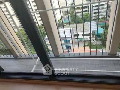 High-rise apartment balcony with city view and modern railing design.
