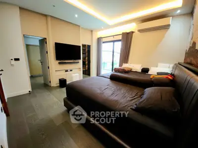 Luxurious bedroom with modern decor and large window for natural light.