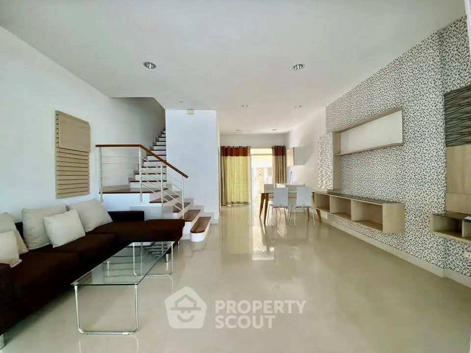 Spacious modern living room with elegant staircase and stylish decor
