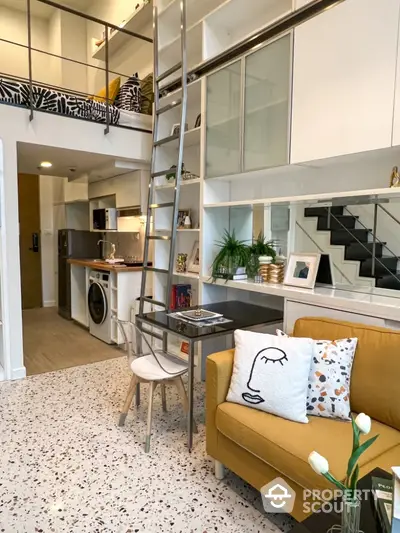 Stylish loft apartment with modern interior, featuring a cozy living area and sleek kitchen.