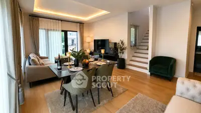 Spacious modern living room with elegant dining area and cozy seating, featuring stylish decor and natural light.
