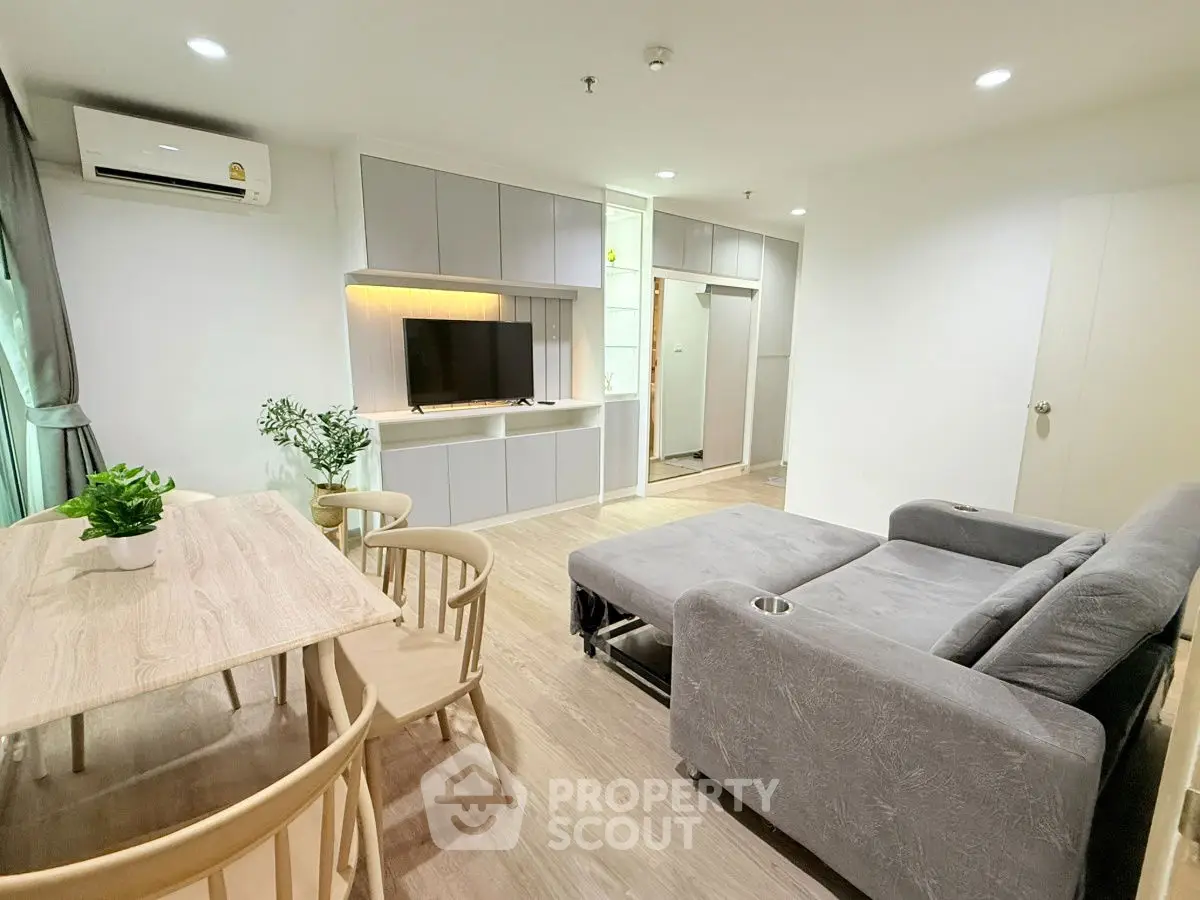 Modern living room with sleek furniture and natural light, perfect for relaxation and entertainment.