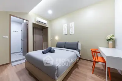 Modern bedroom with ensuite bathroom, featuring stylish decor and cozy ambiance.