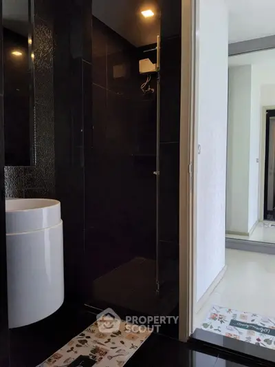 Modern bathroom with sleek black tiles and stylish fixtures