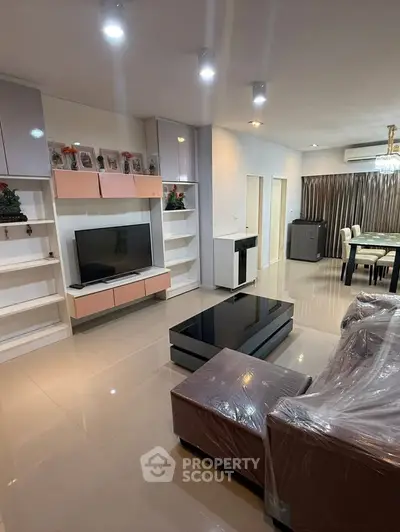 Spacious modern living room with sleek furniture and open dining area