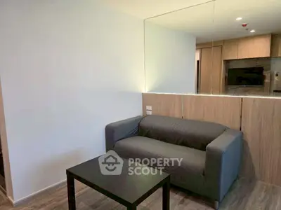 Modern living room with stylish gray sofa and sleek wooden accents.