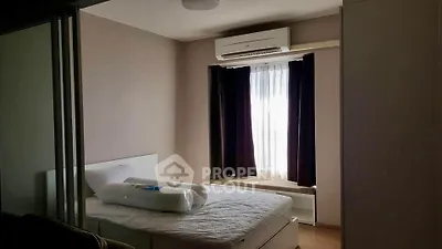 Cozy bedroom with air conditioning and natural light, perfect for relaxation.