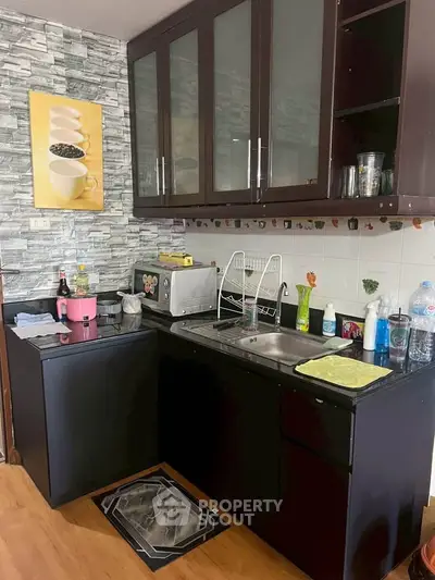 Charming kitchen with modern cabinetry and sleek appliances, perfect for culinary enthusiasts.