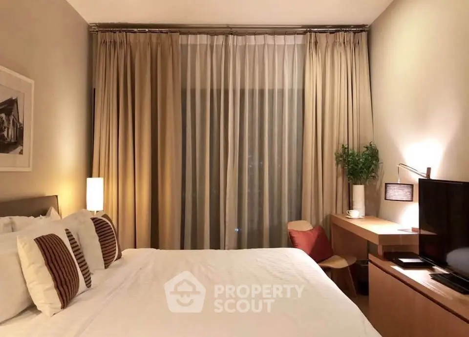 Cozy bedroom with elegant decor, featuring a comfortable bed, stylish desk, and warm lighting for a relaxing ambiance.