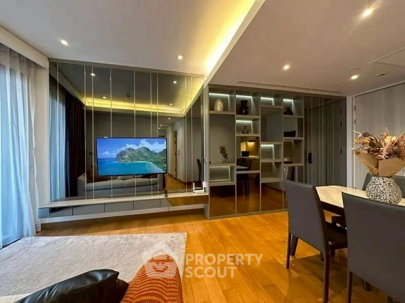Modern living room with mirrored wall and stylish dining area