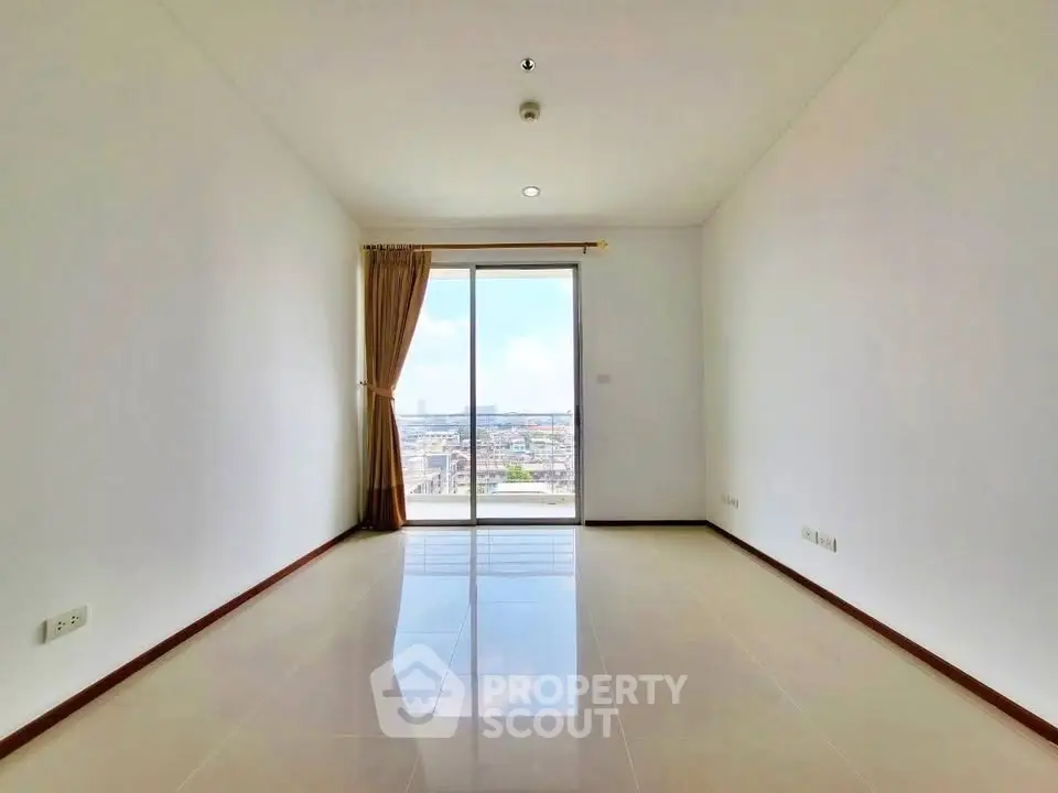 Spacious empty room with large window offering stunning city view, perfect for customization.