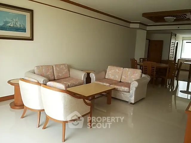 Spacious living room with elegant furniture and dining area in open layout.