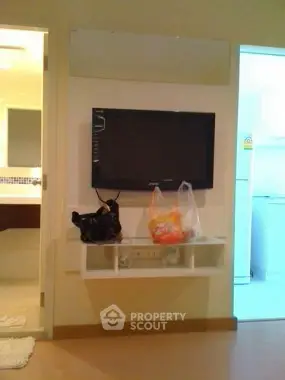 Modern living room with wall-mounted TV and sleek storage shelf