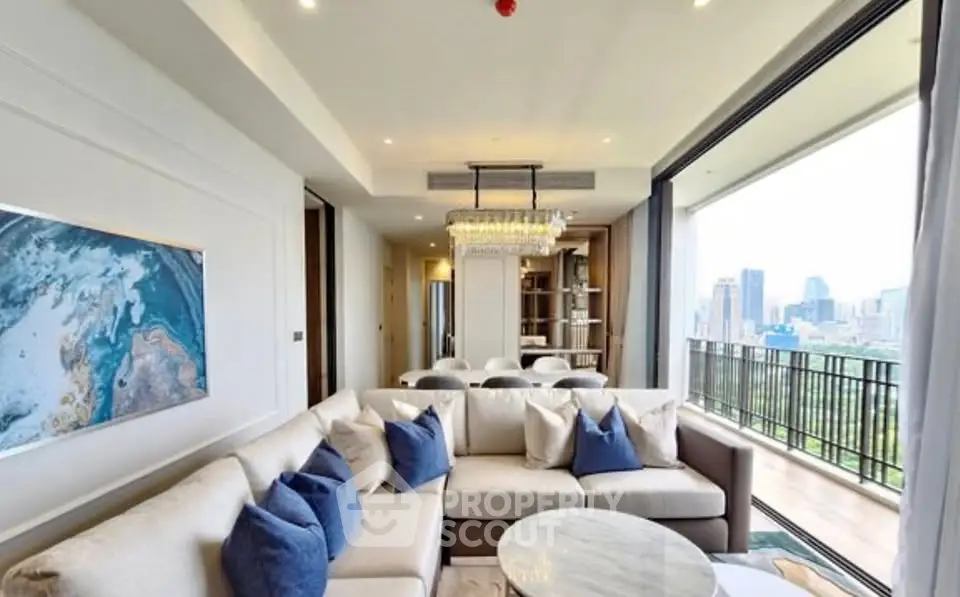 Luxurious living room with modern decor and stunning city view from spacious balcony.