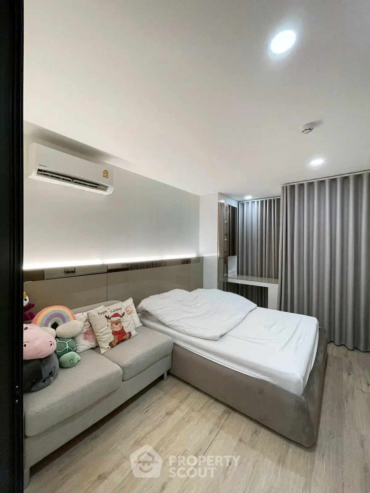 Modern bedroom with cozy sofa and stylish decor in a contemporary apartment.