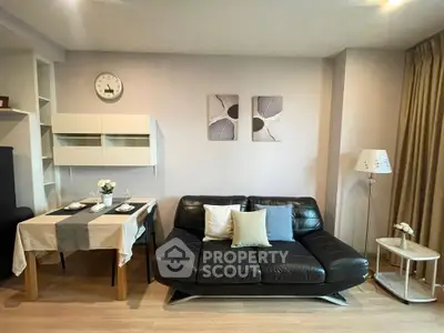 Modern living room with sleek black sofa and elegant dining area