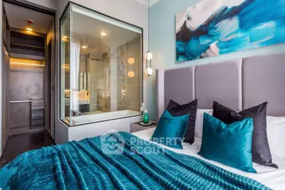 Luxurious bedroom with modern decor and glass-walled bathroom, featuring teal accents and elegant lighting.