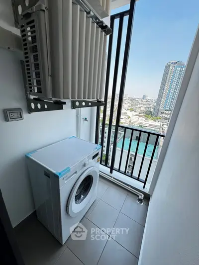 Compact balcony with washing machine and city view in modern apartment.