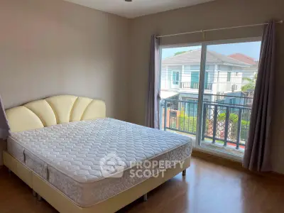 Spacious bedroom with large window and natural light in modern home