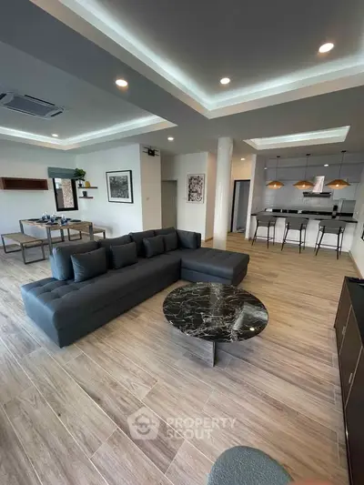 Spacious modern living room with open kitchen and elegant decor