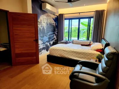 Spacious bedroom with modern decor and large window view.