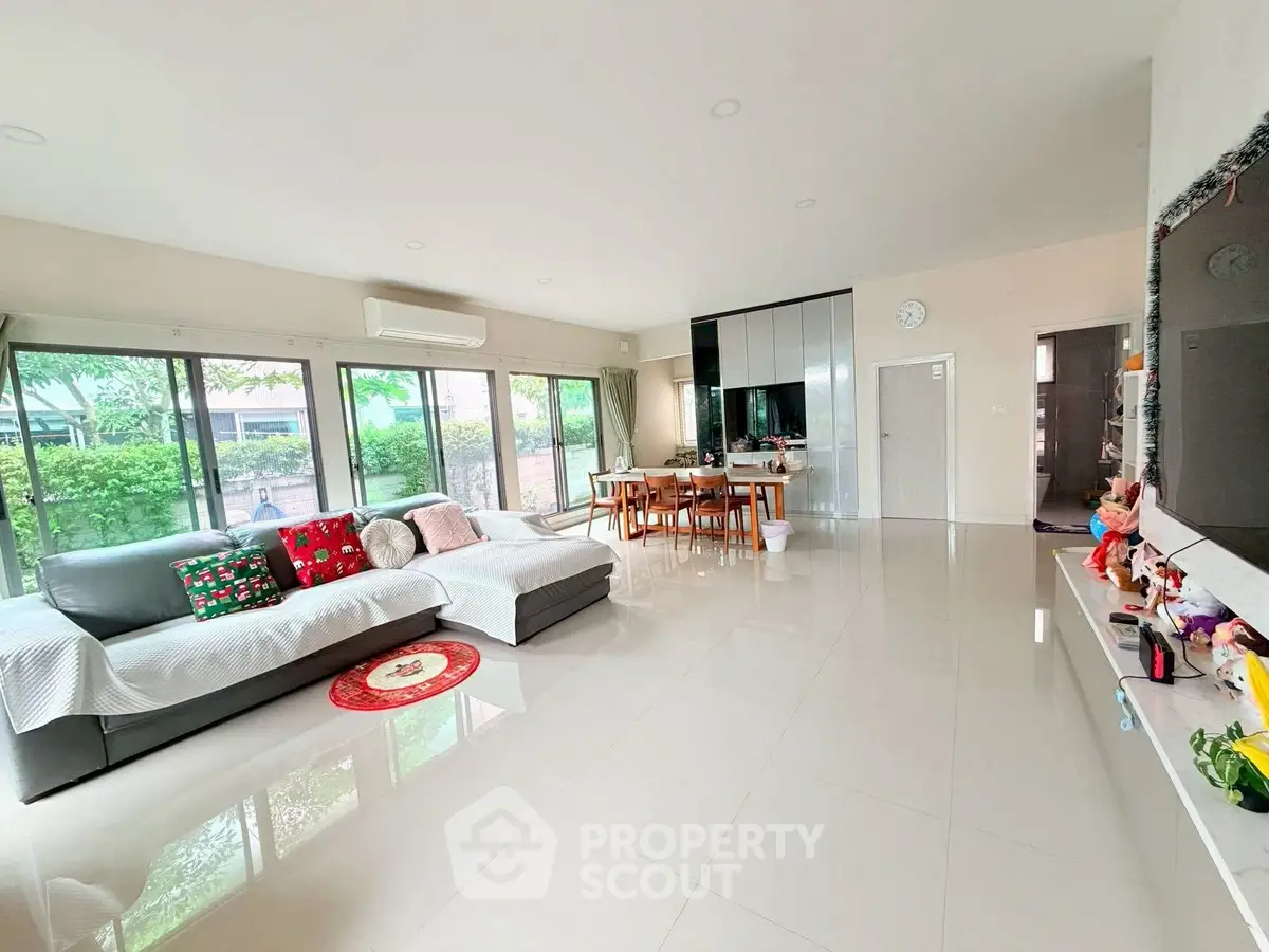 Spacious modern living room with large windows and stylish decor