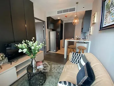 Modern living room with stylish decor and open kitchen layout in a cozy apartment.