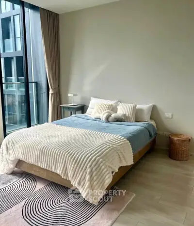 Modern bedroom with large window and stylish decor in urban apartment