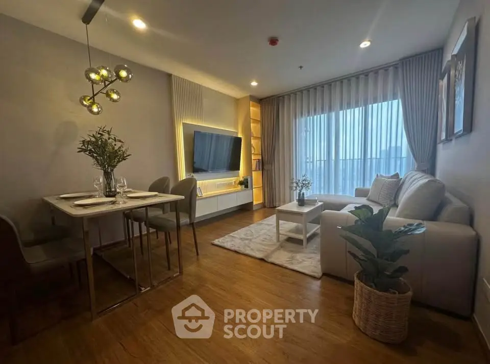 Modern living room with elegant decor, cozy seating, and stylish dining area in a contemporary apartment.