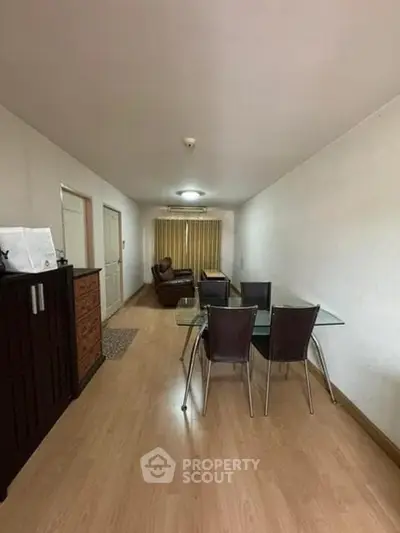 Spacious living room with modern dining set and cozy seating area, perfect for relaxation and entertaining.