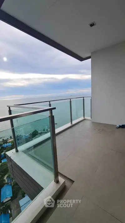 Stunning balcony with breathtaking ocean view and modern glass railing.