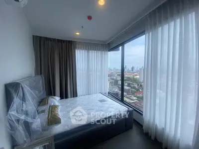 Modern bedroom with panoramic city view and elegant sheer curtains