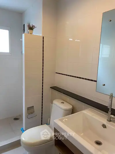 Modern bathroom with sleek white tiles and contemporary fixtures