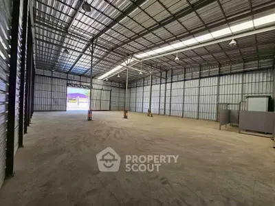 Spacious industrial warehouse with high ceilings and ample storage space.