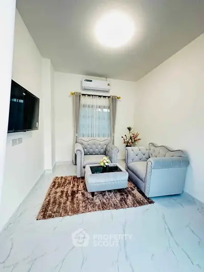 Modern living room with elegant furniture and stylish decor in a bright, airy space.