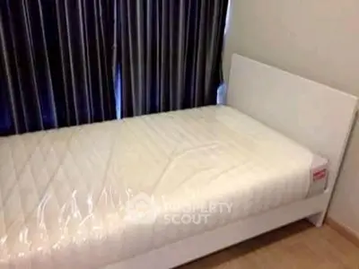 Cozy single bedroom with new mattress and elegant curtains