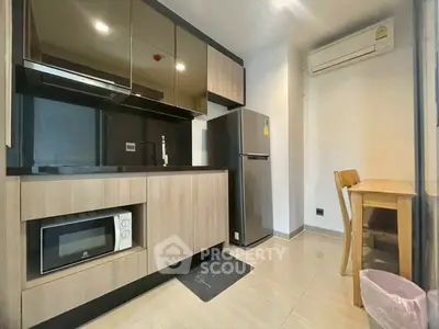 Modern kitchen with sleek cabinetry and appliances in a compact layout