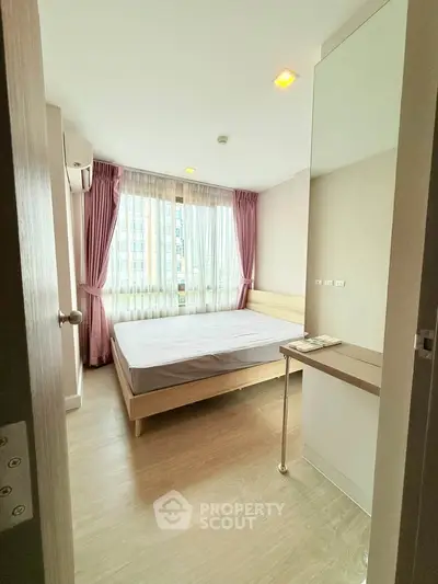 Cozy bedroom with large window and pink curtains in modern apartment