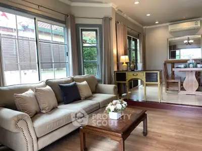 Spacious living room with elegant decor and large windows for natural light.