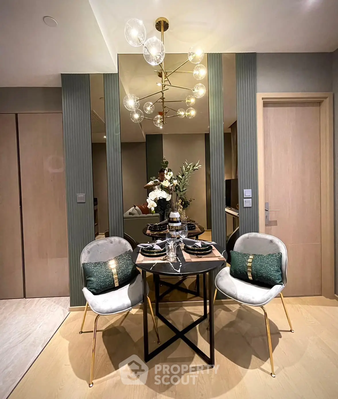 Elegant dining area with modern chandelier and stylish decor in a contemporary apartment.