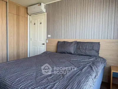 Cozy bedroom with modern decor and air conditioning in a stylish apartment.