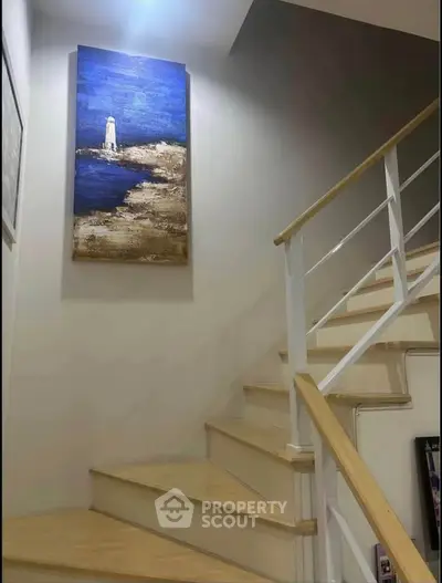 Stylish staircase with modern railing and elegant wall art in a contemporary home.