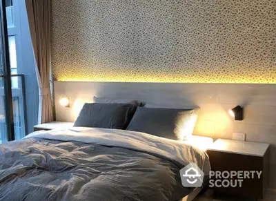 Modern bedroom with stylish patterned wallpaper, cozy lighting, and a comfortable bed, perfect for relaxation and a peaceful night's sleep.