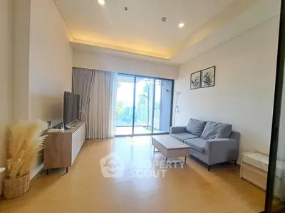Spacious modern living room with large windows and city view, perfect for relaxation and entertainment.